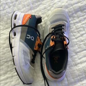 On Running White and Orange Athletic Shoes Modern Design